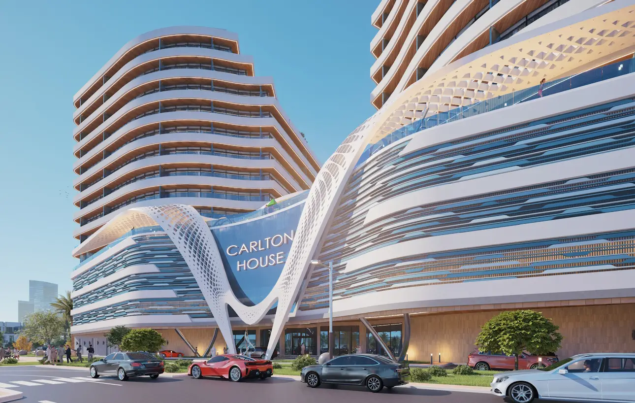 Exterior view of the modern Carlton House building, featuring striking white lattice architectural elements curving around the main entrance and the illuminated name 'CARLTON HOUSE'.
